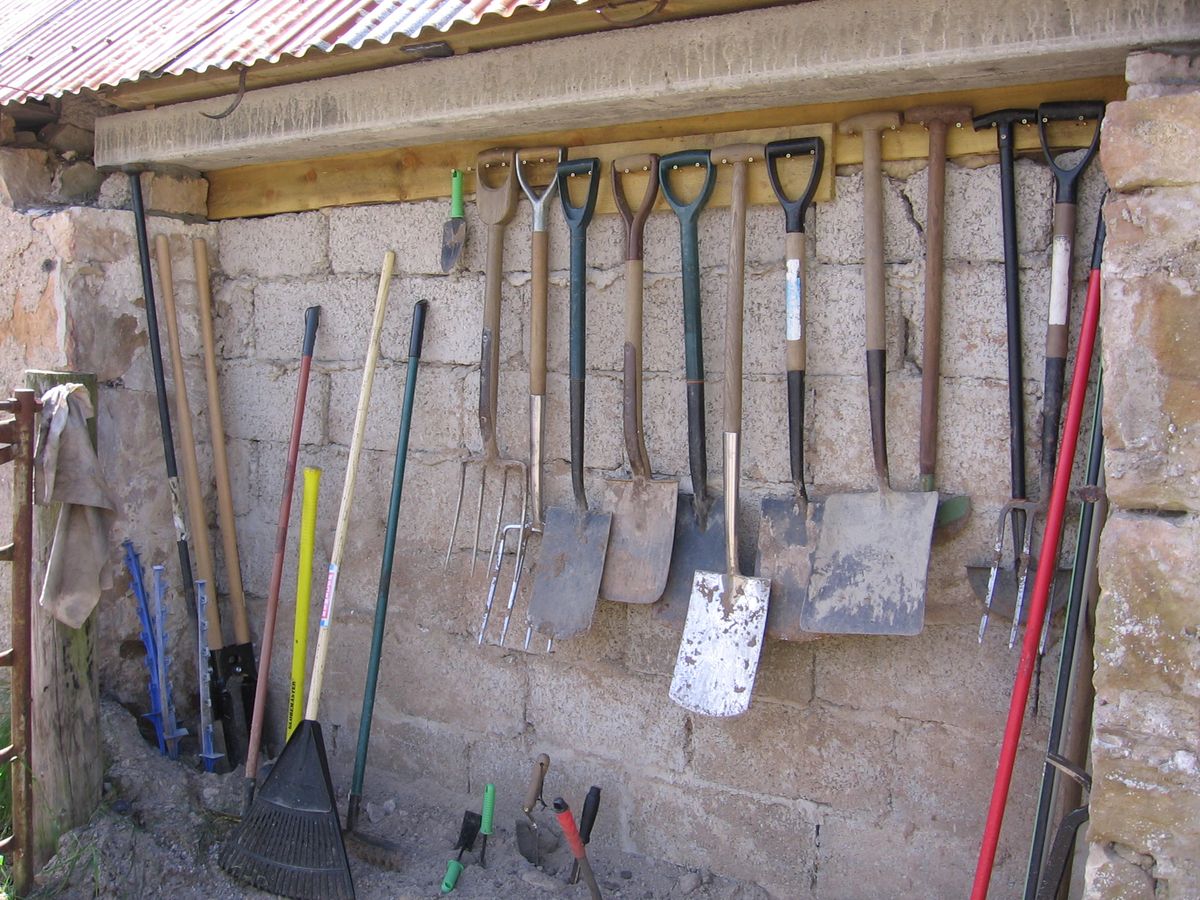 organized gardening tools in a creative storage space