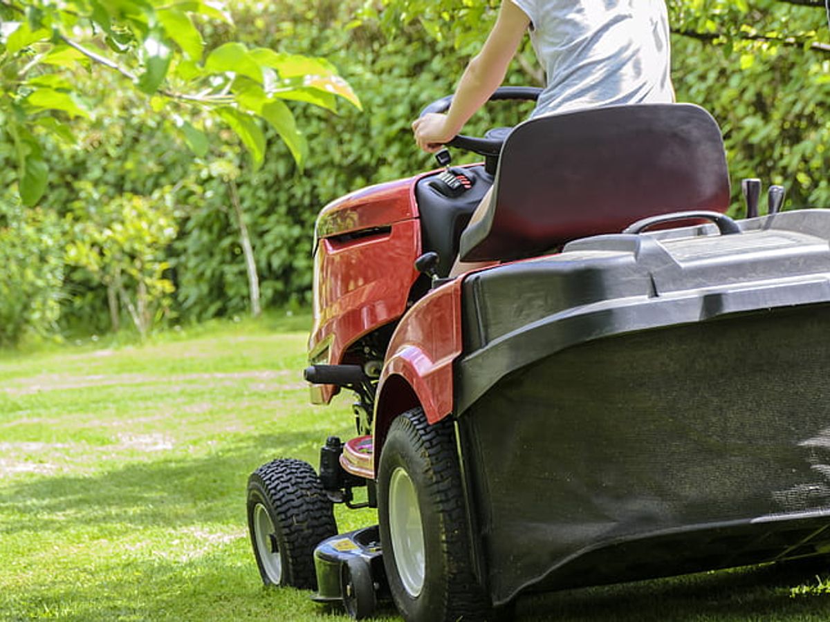 lawn mower in a well-maintained garden